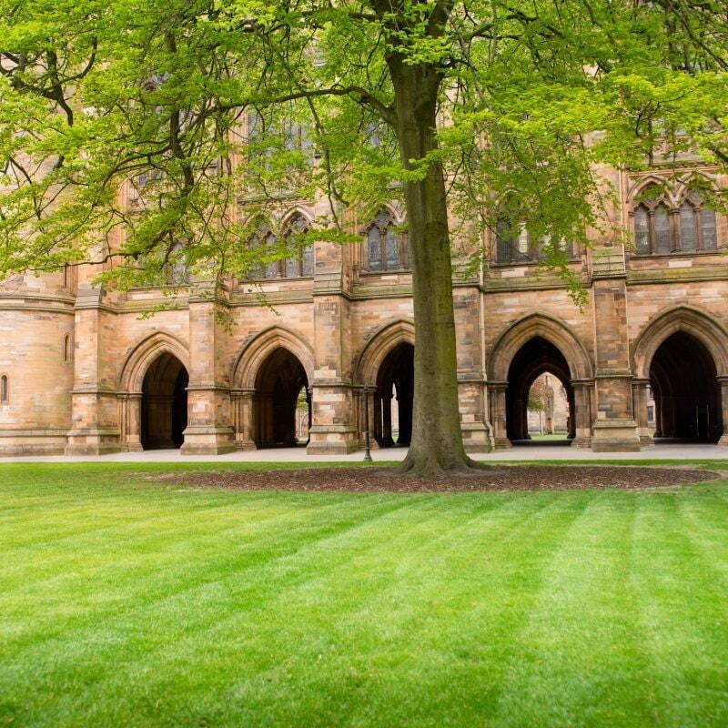 Cloisters beyond a grass lawn