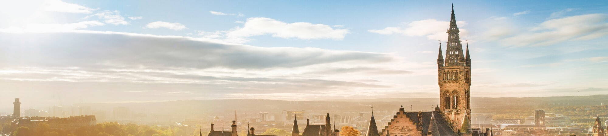 Image of the Gilbert Scott Building Tower, with the Glasgow skyline in the background